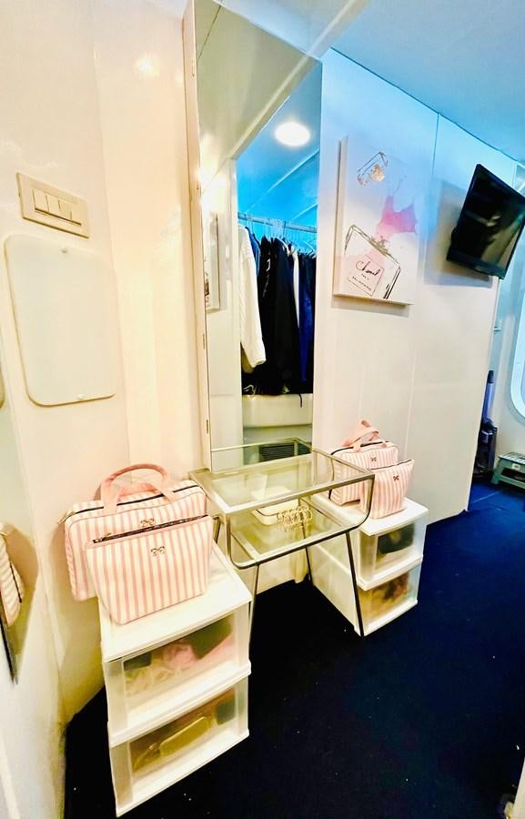 a room with a desk and a mirror aboard PACIFIC PEARL Yacht for Sale