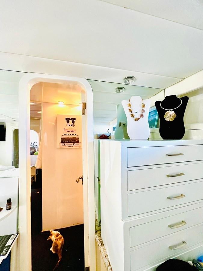a room with a dresser and a dog in it aboard PACIFIC PEARL Yacht for Sale