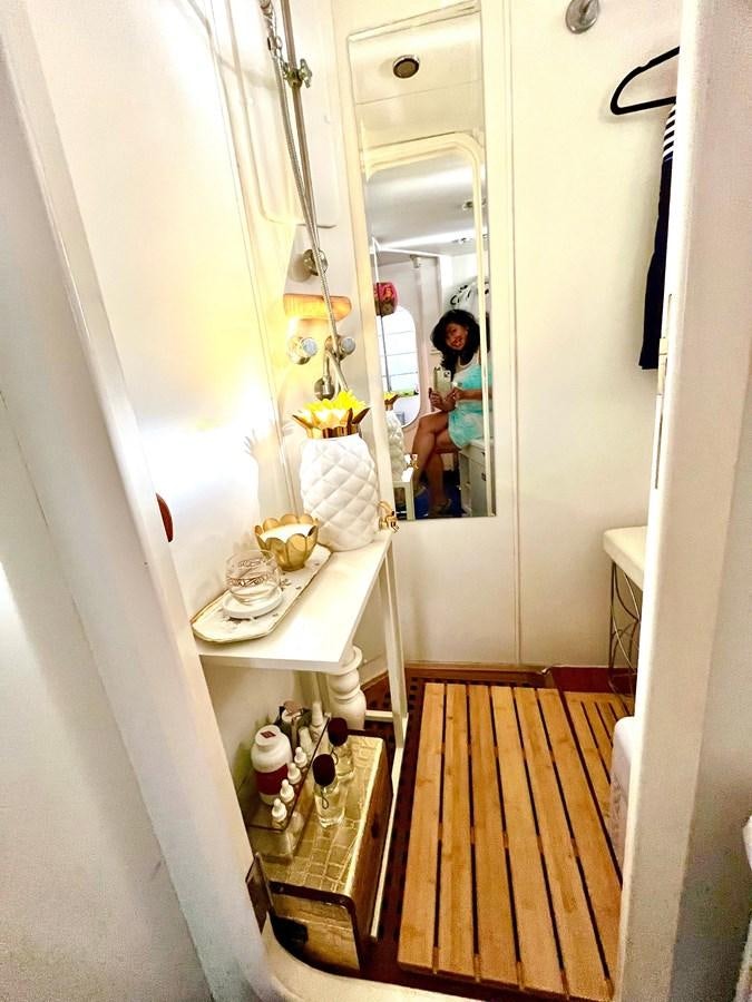 a person taking a picture of themselves in a mirror aboard PACIFIC PEARL Yacht for Sale