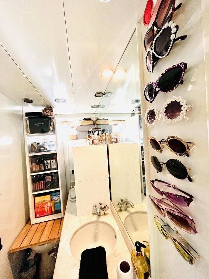 a bathroom with a sink and a mirror aboard PACIFIC PEARL Yacht for Sale