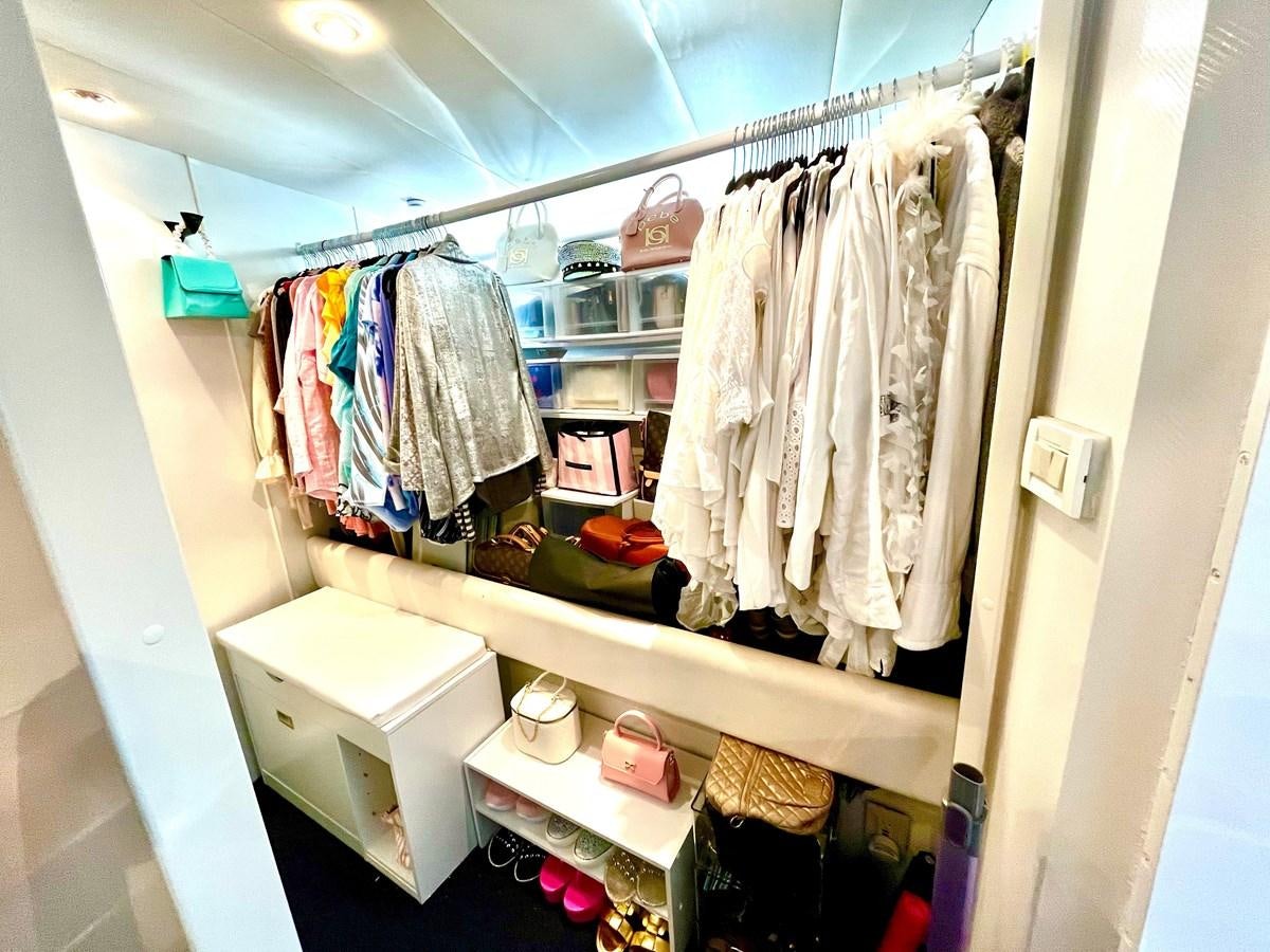 a closet full of clothes aboard PACIFIC PEARL Yacht for Sale