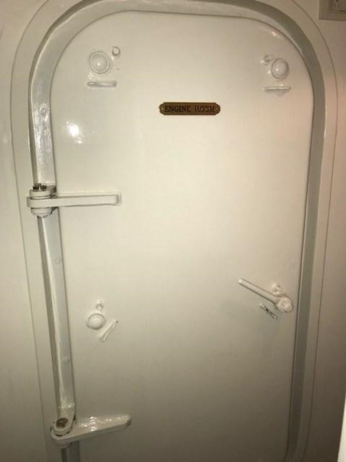 a white door with knobs aboard PACIFIC PEARL Yacht for Sale