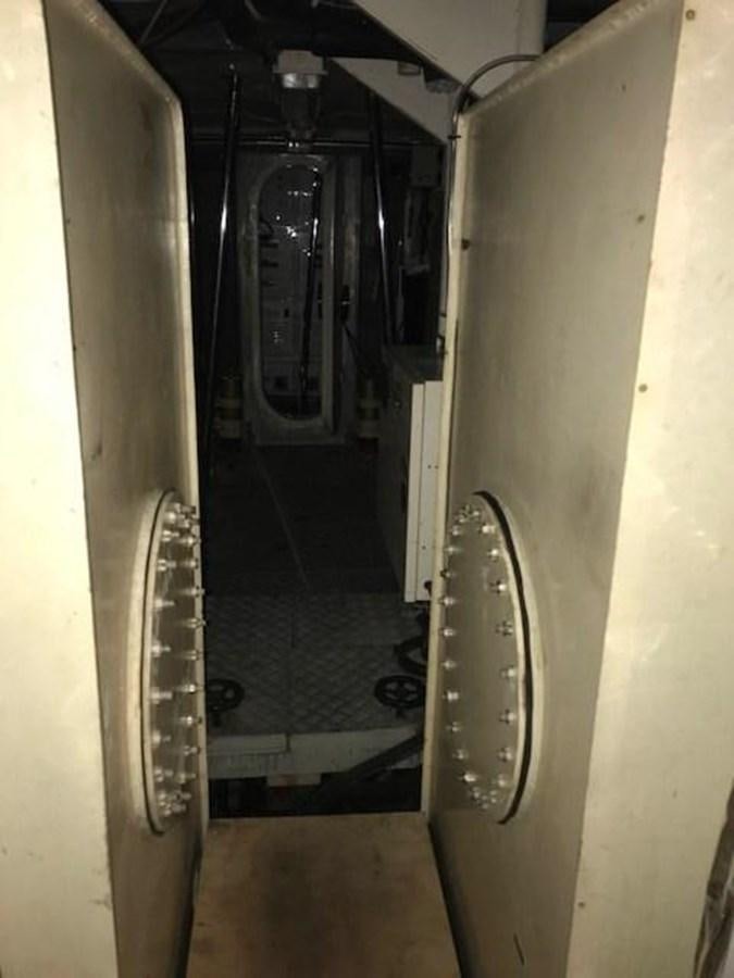 a hallway with a door open aboard PACIFIC PEARL Yacht for Sale