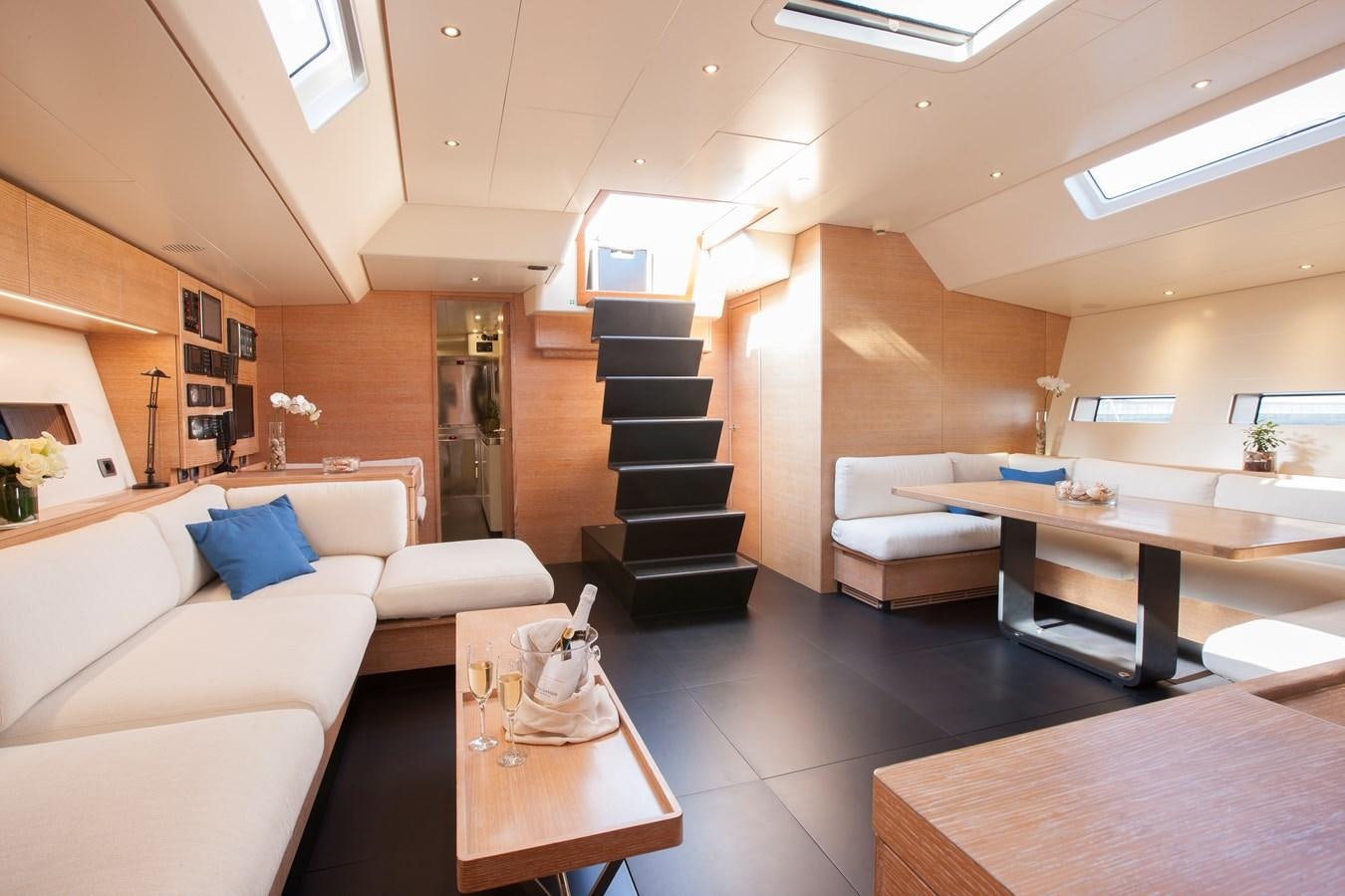 a living room with a staircase aboard INTI CUBE Yacht for Sale