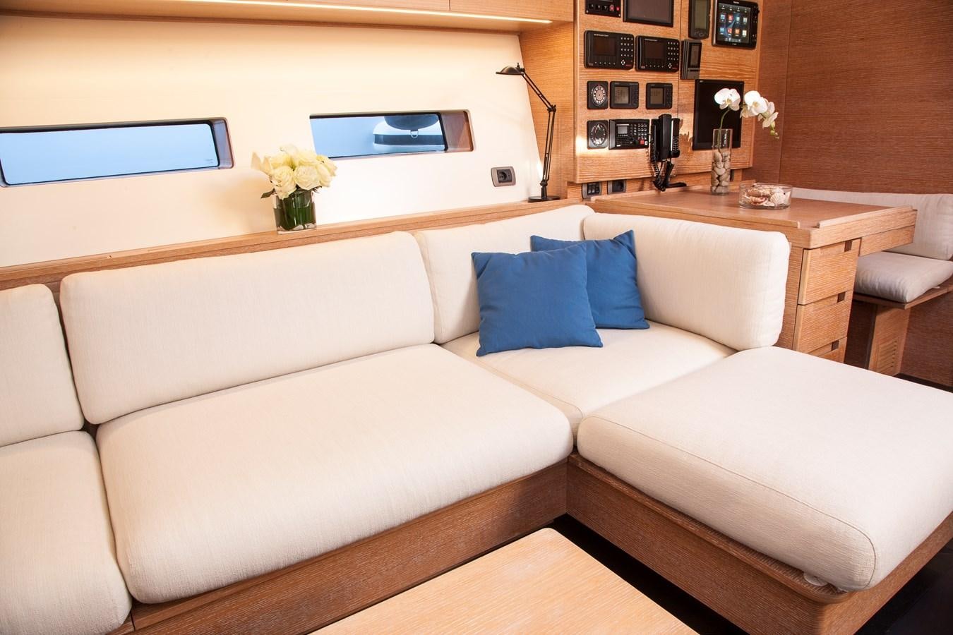 a white couch with blue pillows aboard INTI CUBE Yacht for Sale