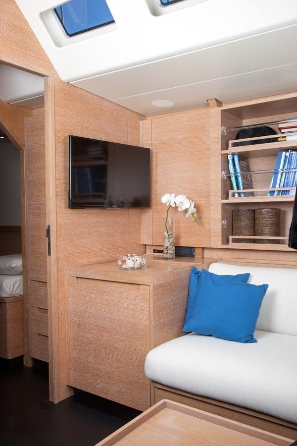 a living room with a couch and a tv aboard INTI CUBE Yacht for Sale