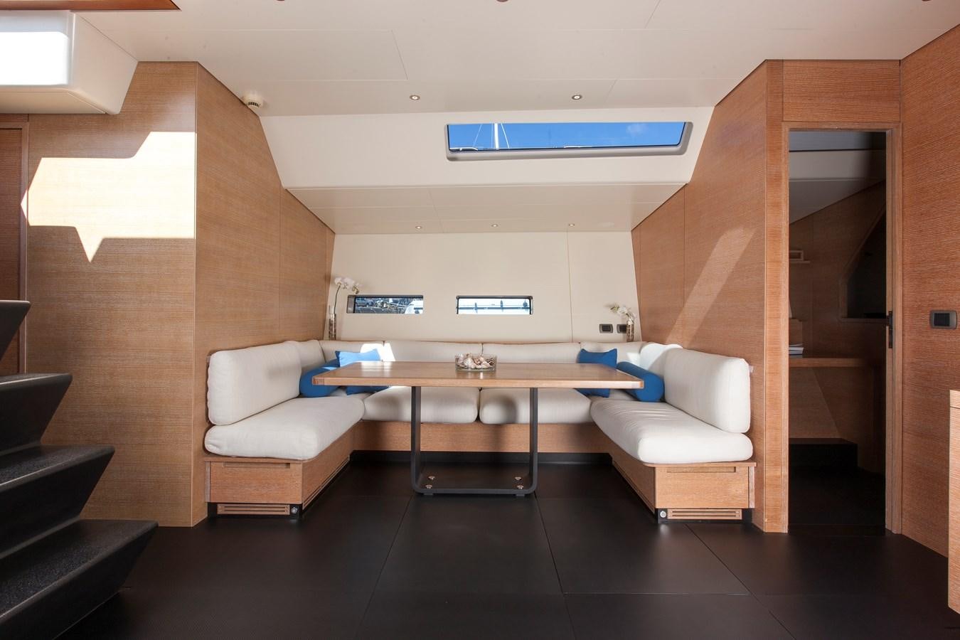 a room with a table and chairs aboard INTI CUBE Yacht for Sale