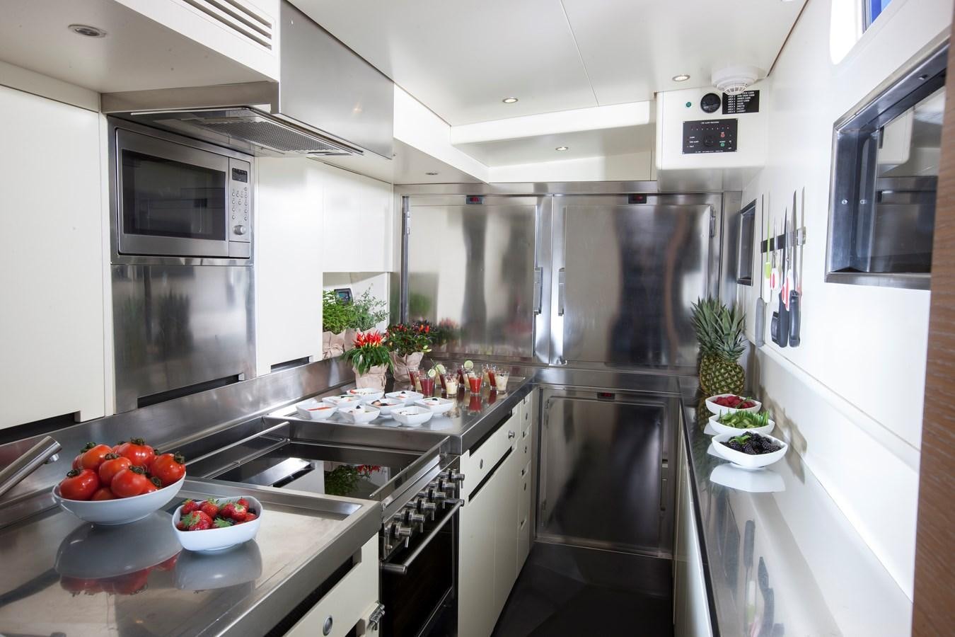 a kitchen with a large island aboard INTI CUBE Yacht for Sale