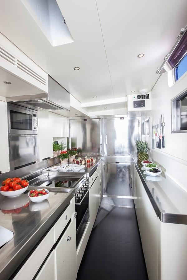 a kitchen with a black countertop aboard INTI CUBE Yacht for Sale
