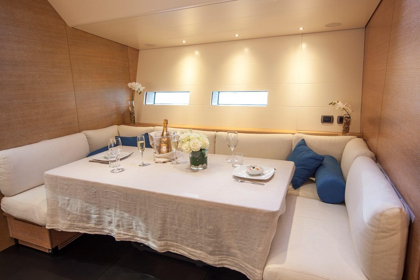 a room with a table and chairs aboard INTI CUBE Yacht for Sale