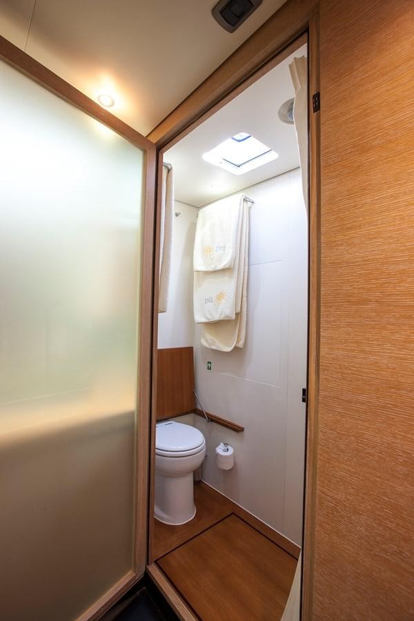 a bathroom with a toilet and a mirror aboard INTI CUBE Yacht for Sale