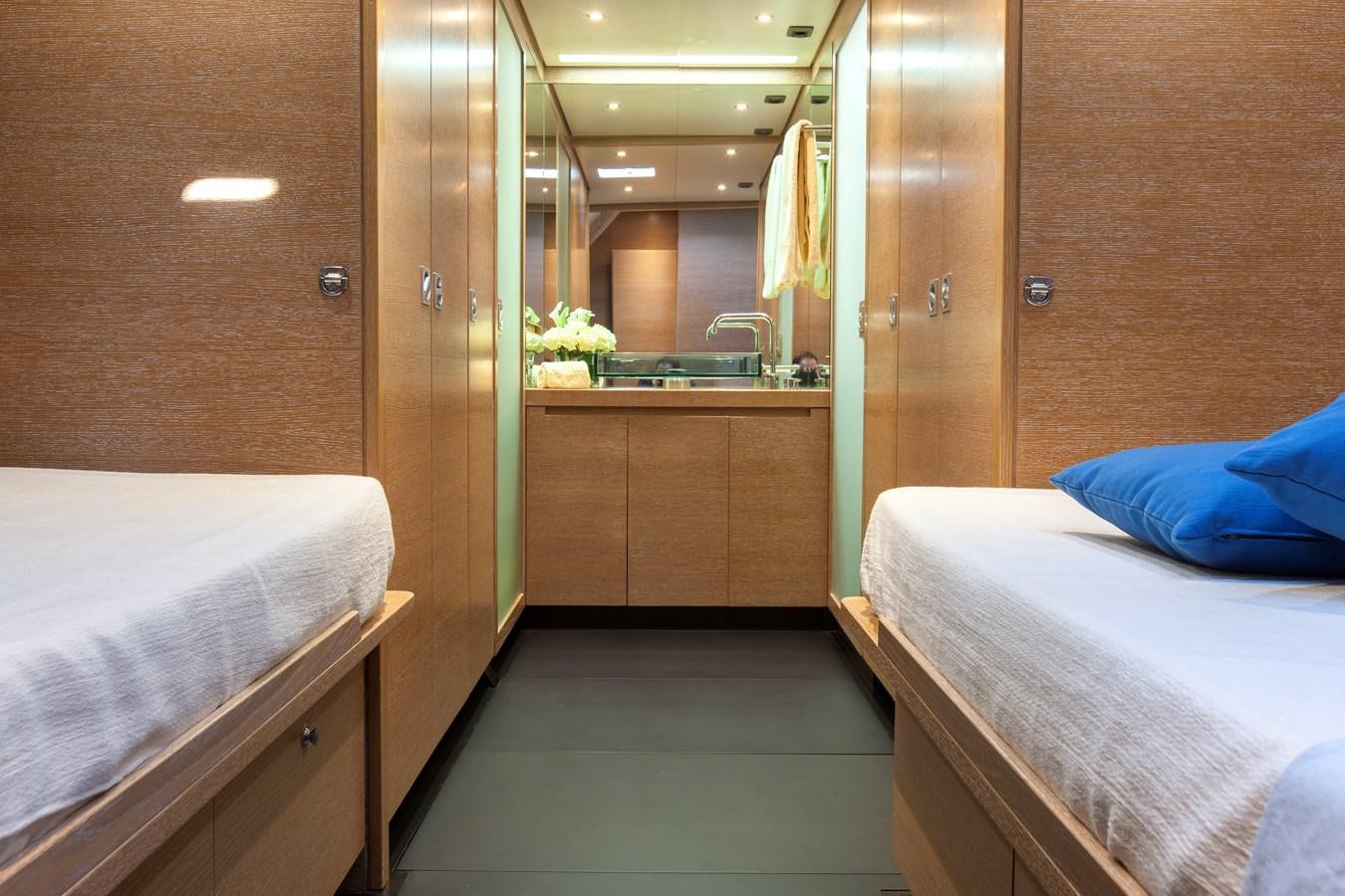 a room with a bed and a desk aboard INTI CUBE Yacht for Sale