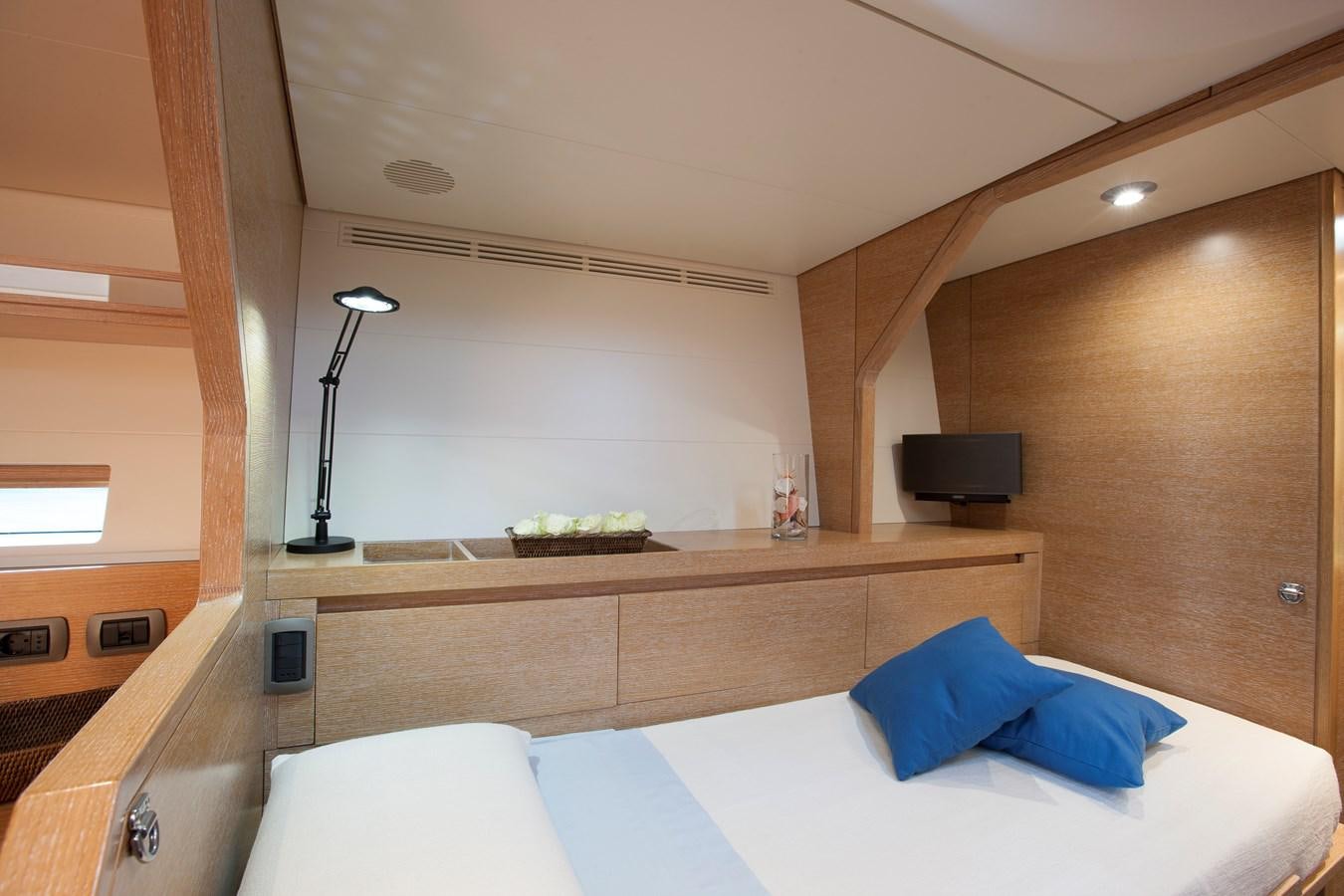 a room with a bed and a television aboard INTI CUBE Yacht for Sale