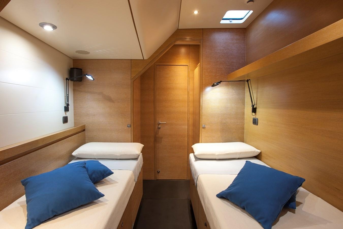 a room with a bed and a wood door aboard INTI CUBE Yacht for Sale