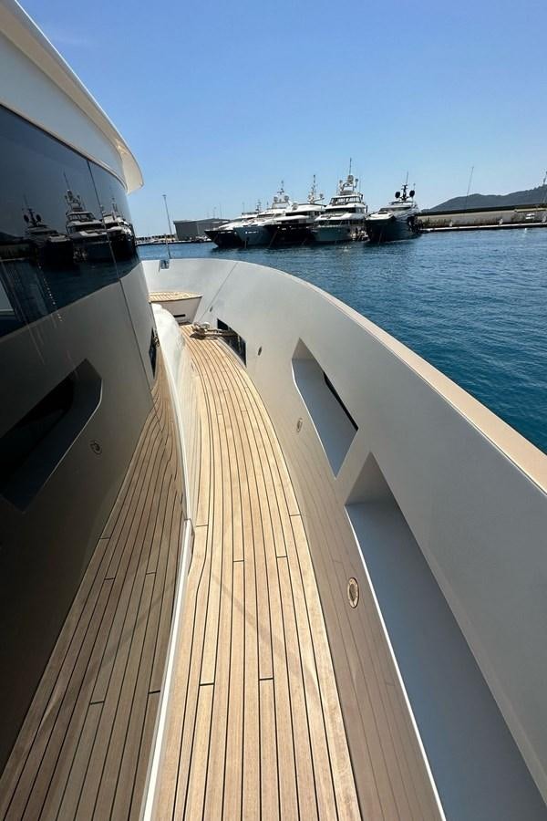 a deck with a boat in the water aboard REKOMA Yacht for Sale