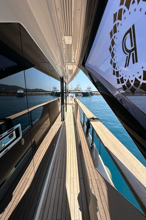 a deck with a railing and a sign on the side aboard REKOMA Yacht for Sale