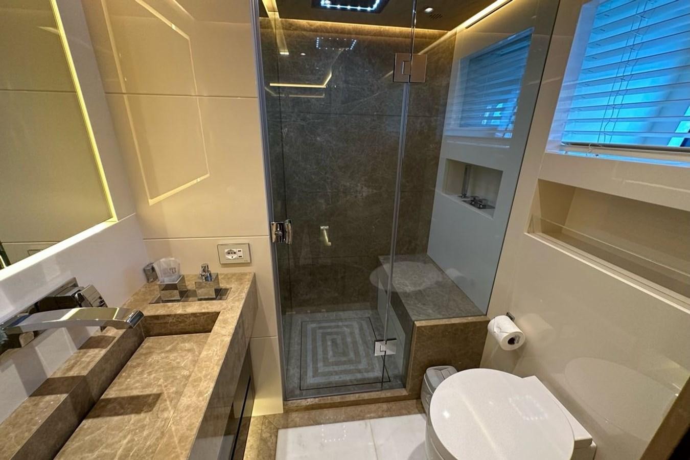 a bathroom with a glass shower aboard REKOMA Yacht for Sale