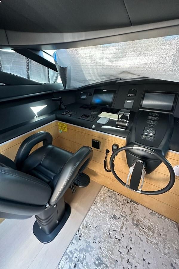 a black office chair next to a black computer desk aboard REKOMA Yacht for Sale