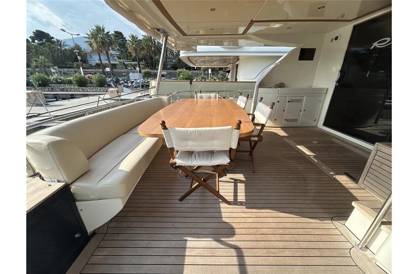 a table and chairs on a deck aboard 888 Yacht for Sale