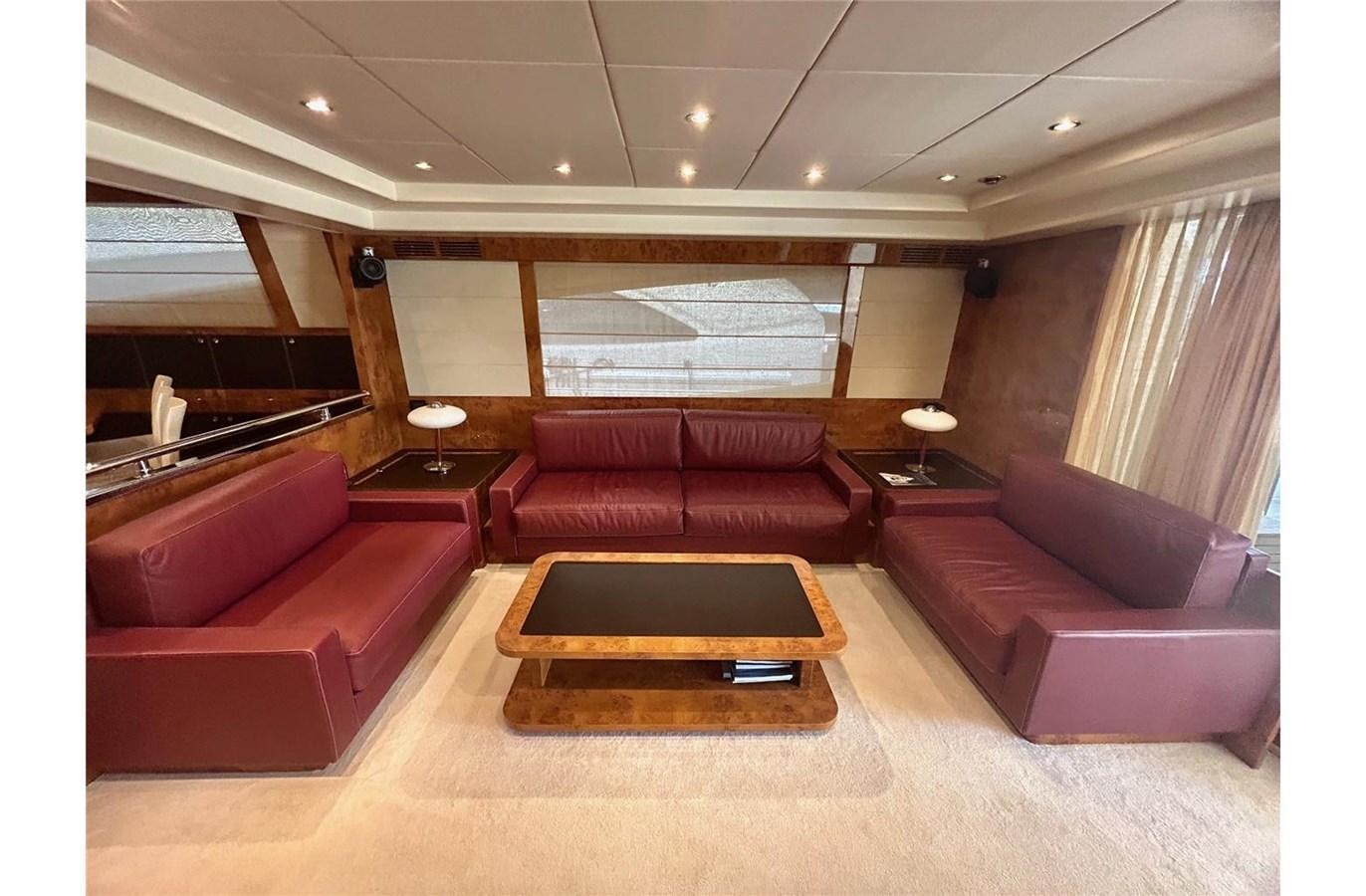 a room with couches and a table aboard 888 Yacht for Sale