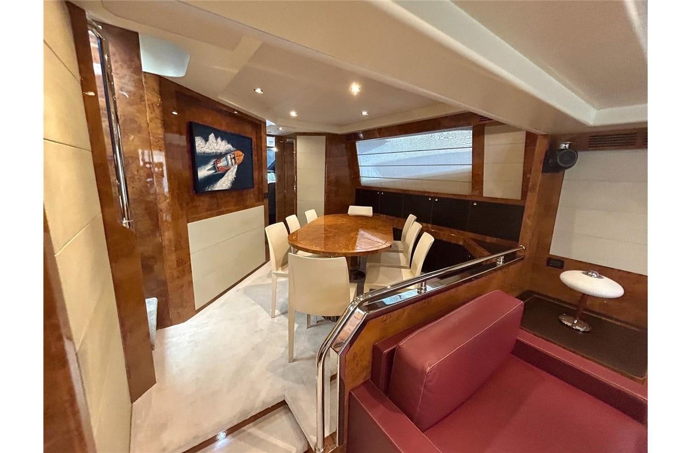 a room with a table and chairs aboard 888 Yacht for Sale