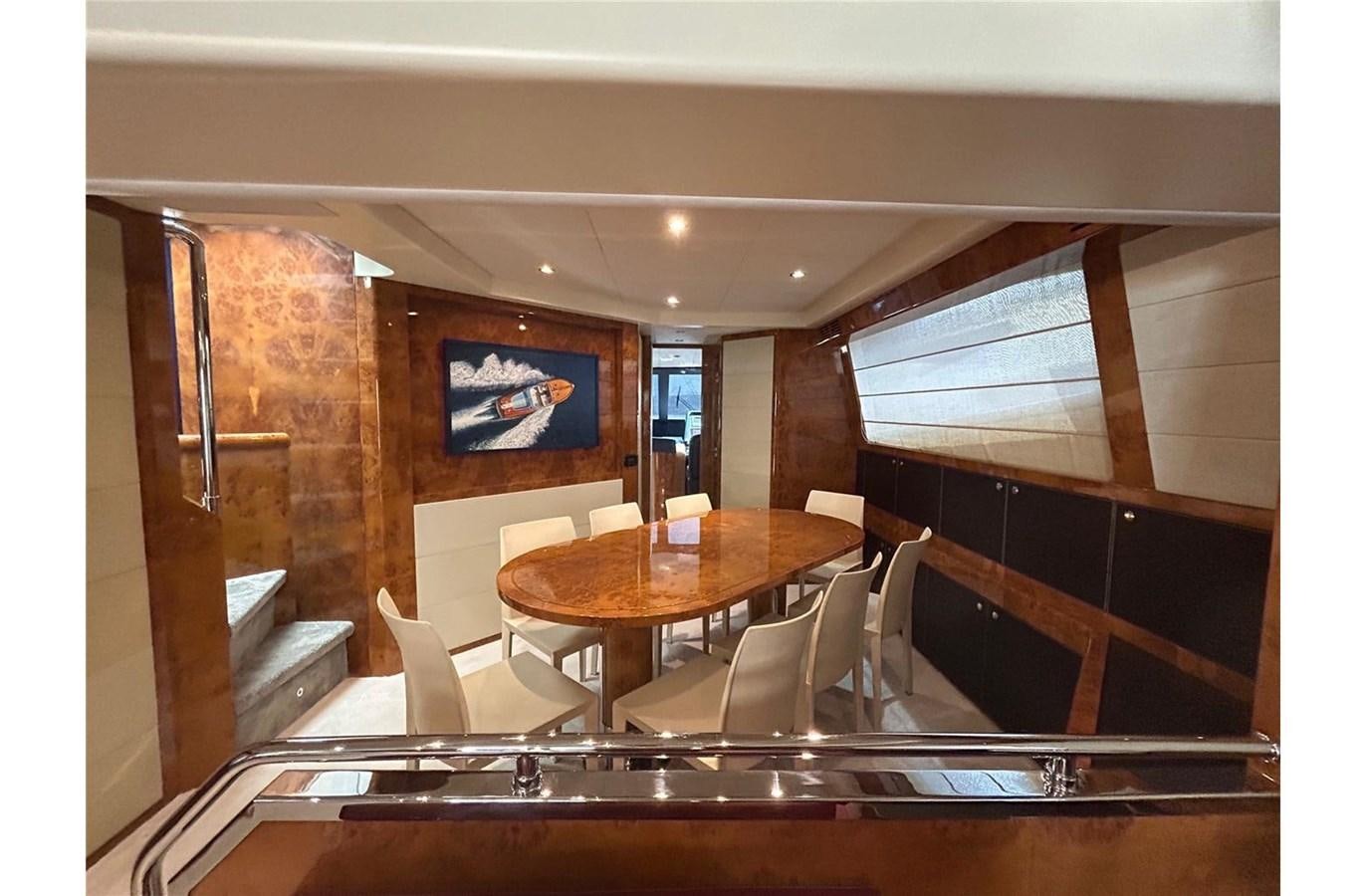 a room with a table and chairs aboard 888 Yacht for Sale