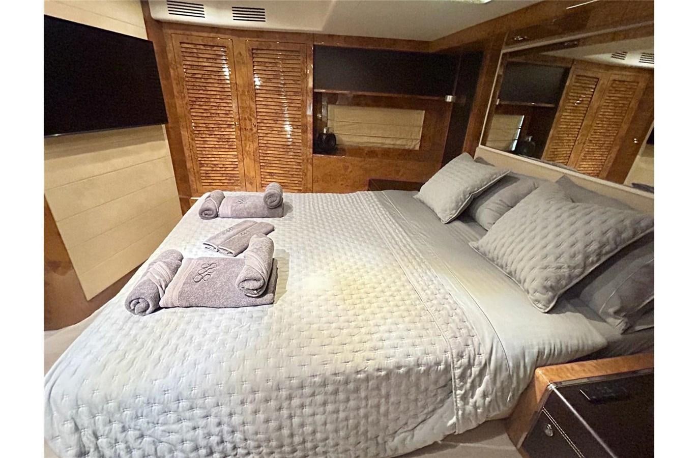 a bed with white sheets aboard 888 Yacht for Sale