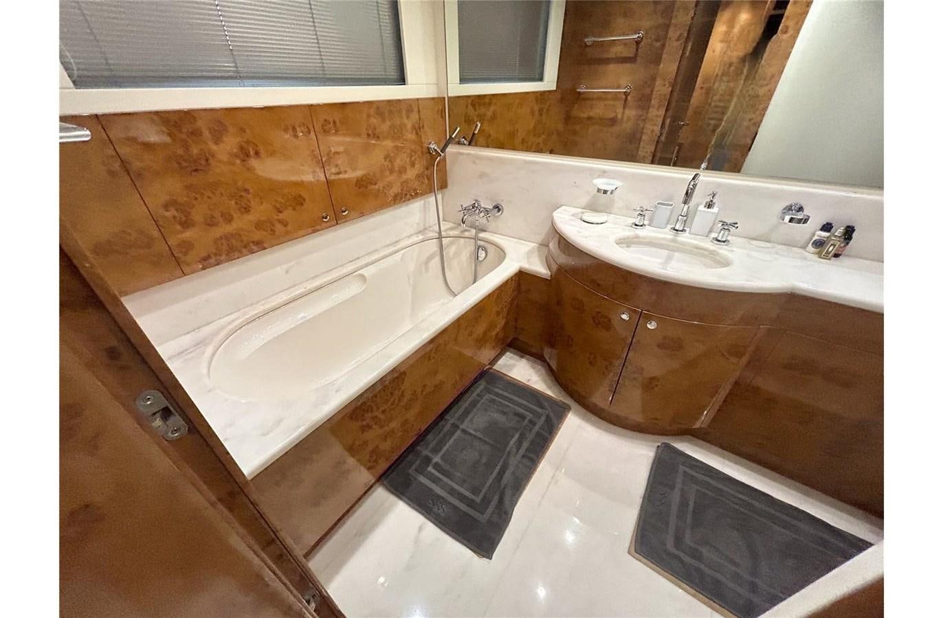 a bathroom with a tub sink and a sink aboard 888 Yacht for Sale