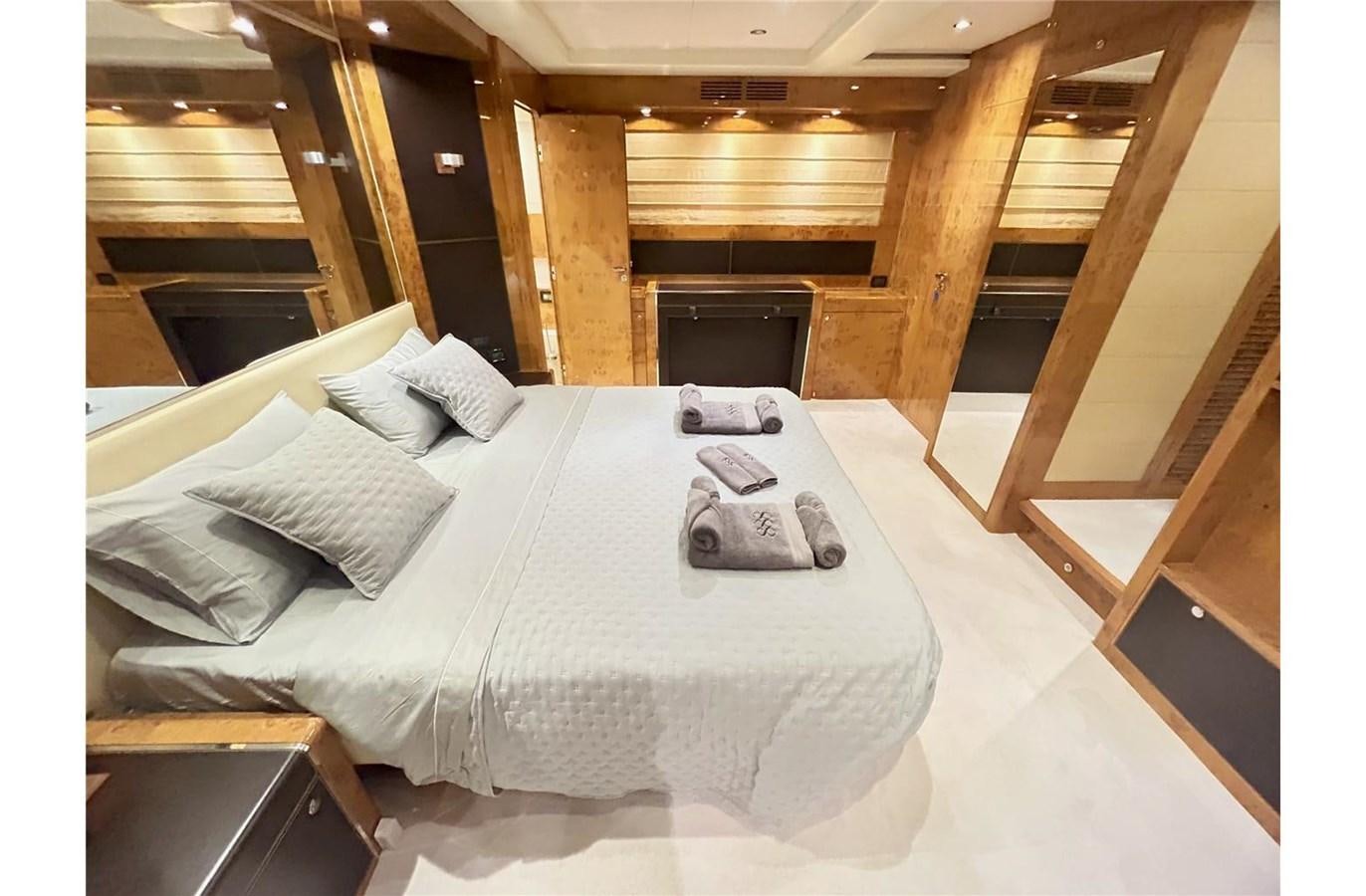 a bed with a white sheet and pillows on it aboard 888 Yacht for Sale