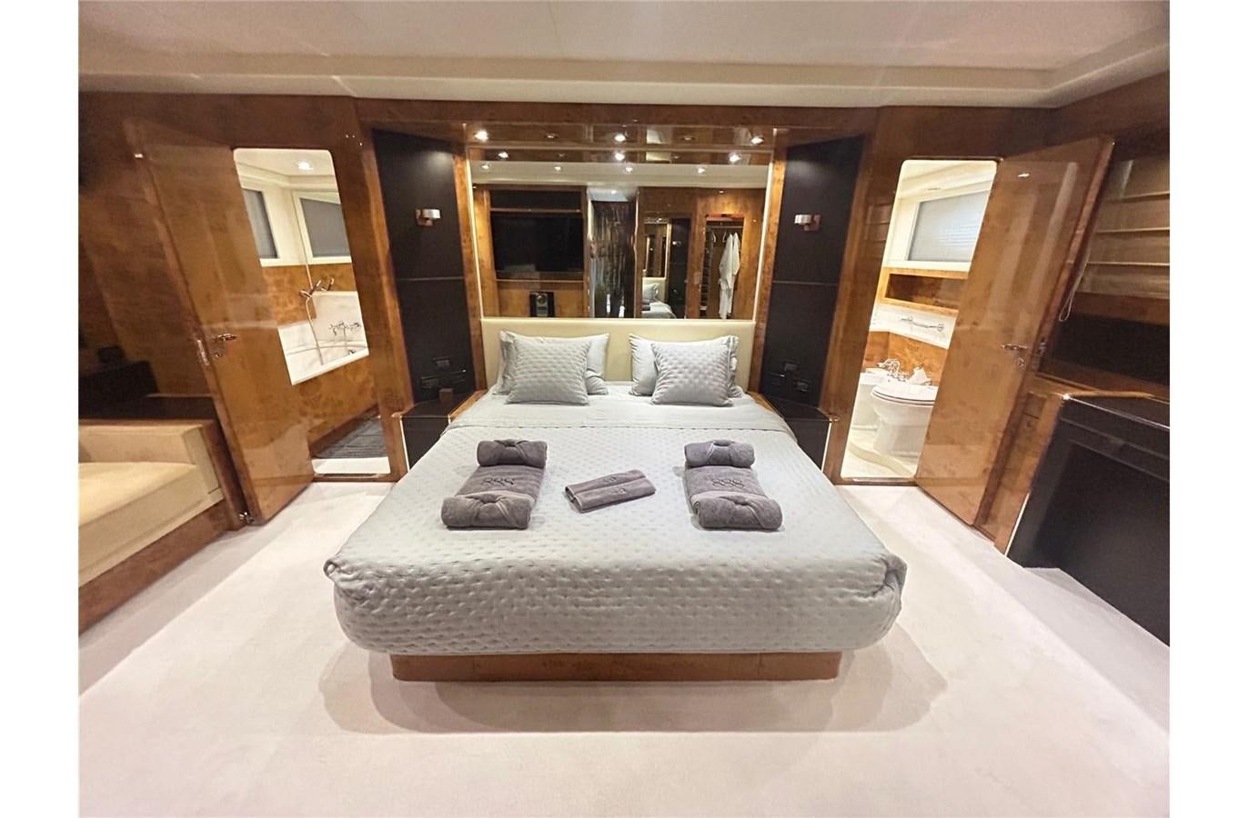 a large bed with many pillows aboard 888 Yacht for Sale