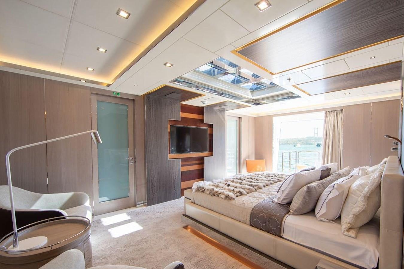 a bedroom with a bed and a television aboard STARBURST III Yacht for Sale