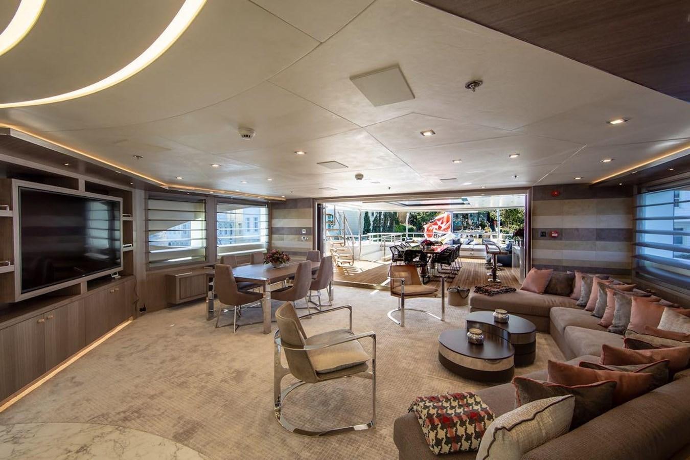 a living room with a large screen aboard STARBURST III Yacht for Sale