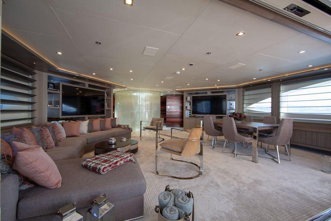 a living room with a couch and a table aboard STARBURST III Yacht for Sale
