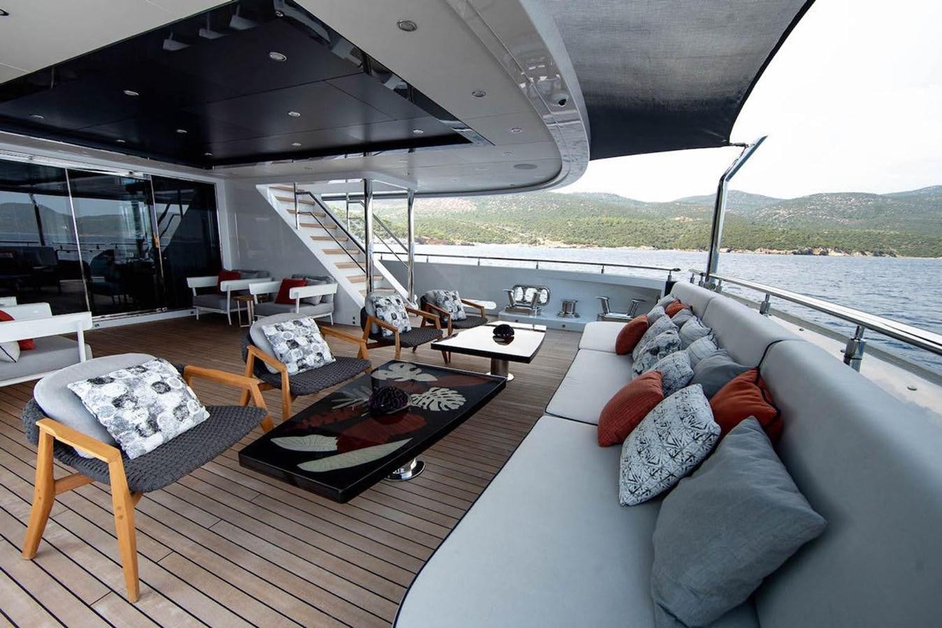 a living room with a couch and a table aboard STARBURST III Yacht for Sale