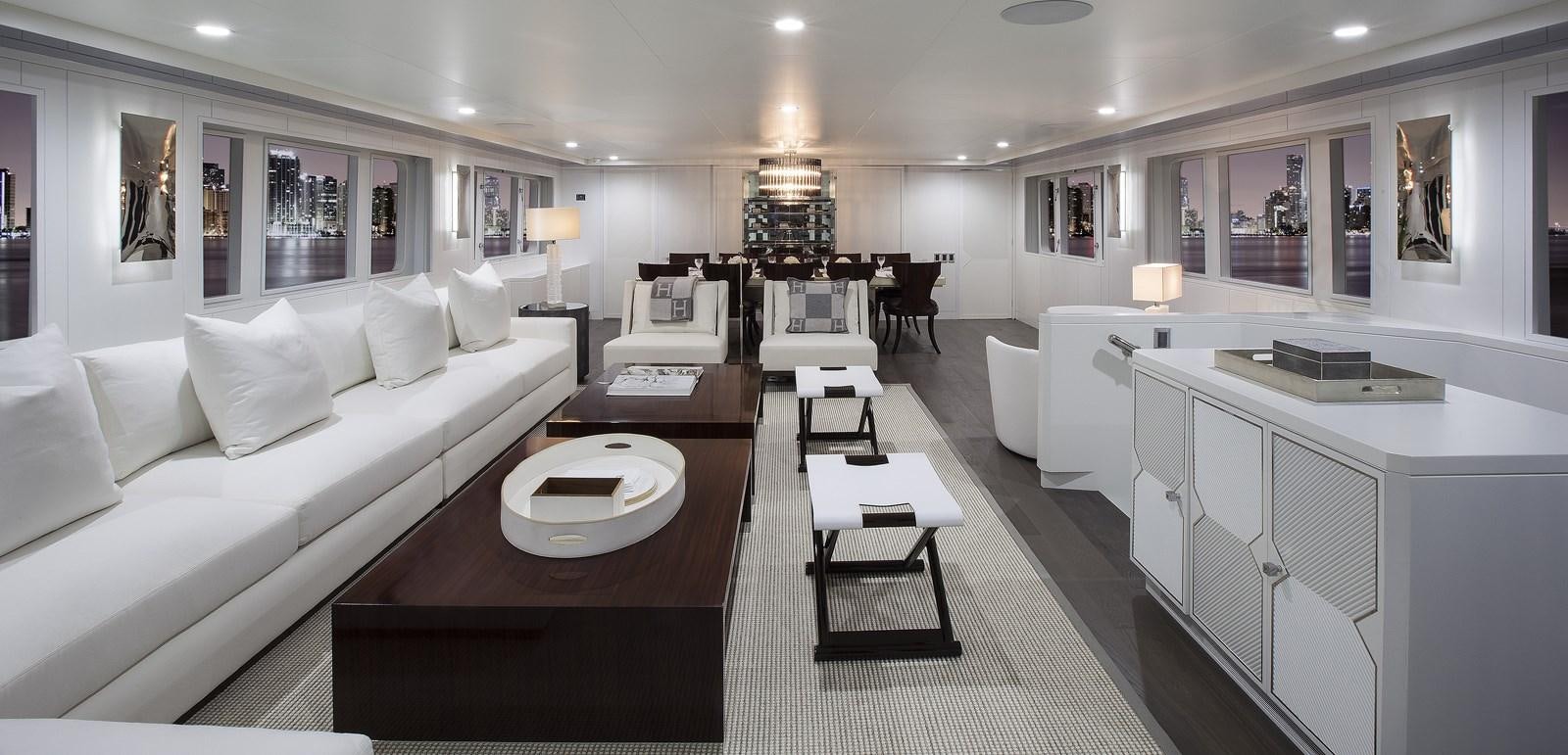 a large white living room with a white couch and a table aboard BG Yacht for Sale