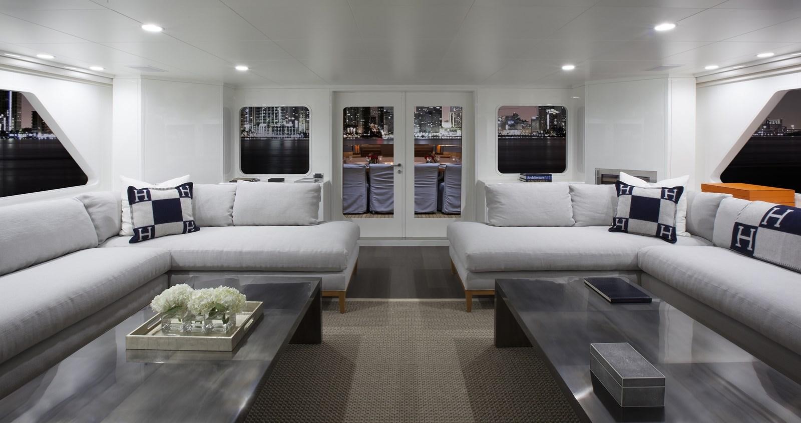 a living room with a white couch and a coffee table aboard BG Yacht for Sale