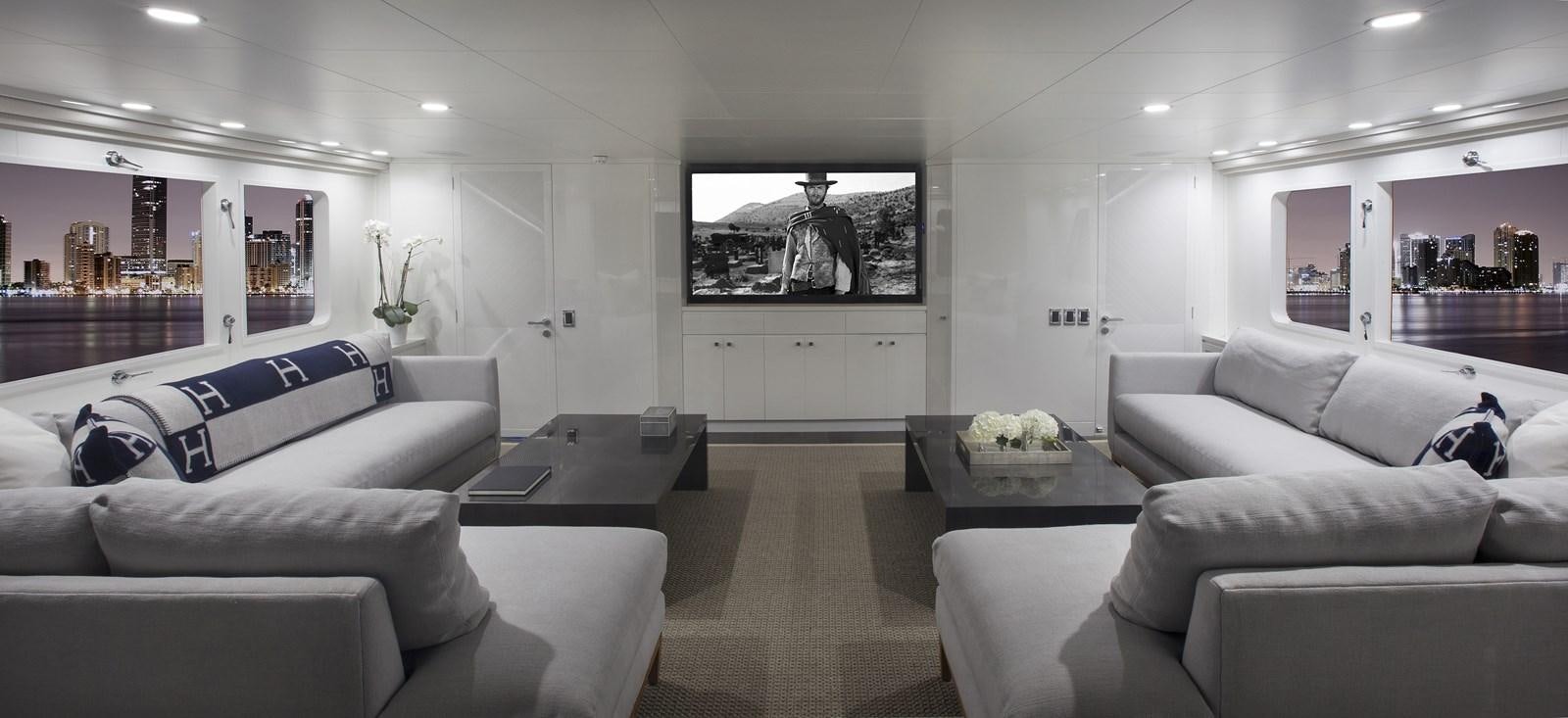 a living room with white couches aboard BG Yacht for Sale