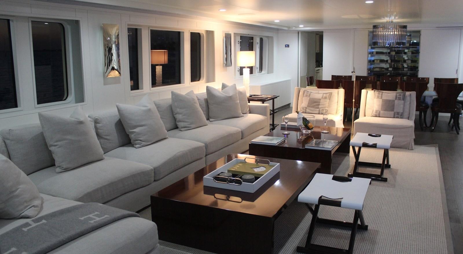 a living room with a white couch and a coffee table aboard BG Yacht for Sale