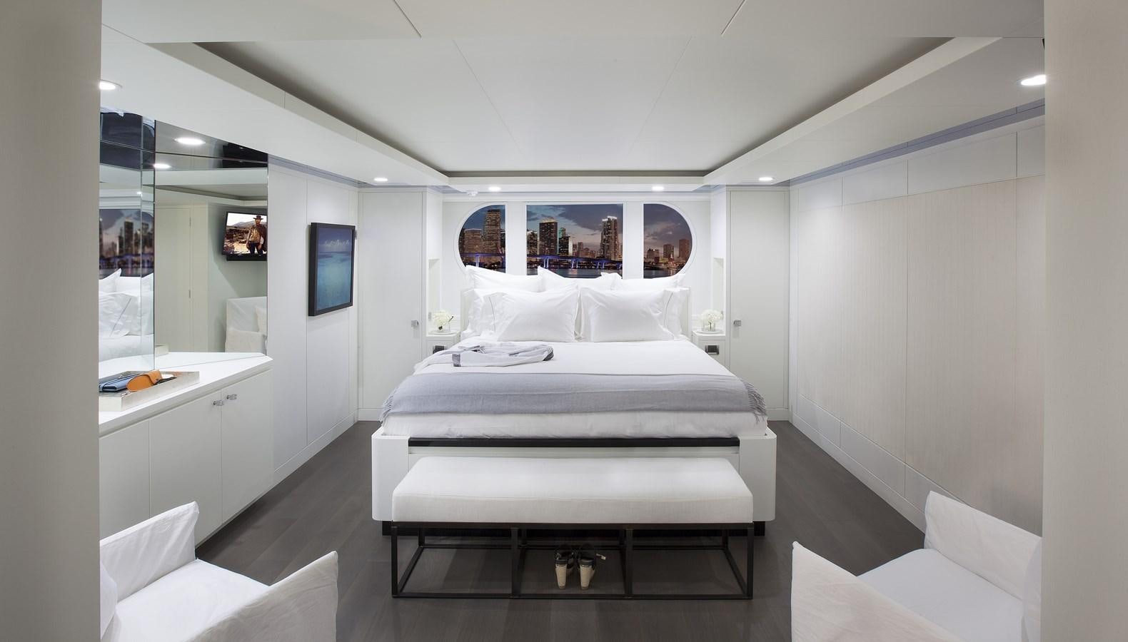a room with a bed and a desk aboard BG Yacht for Sale