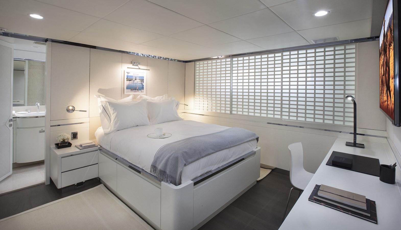 a room with a bed and a desk aboard BG Yacht for Sale