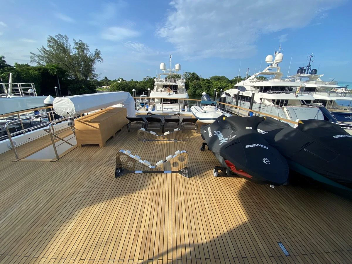 a deck with boats and a chair aboard PERSISTENCE Yacht for Sale