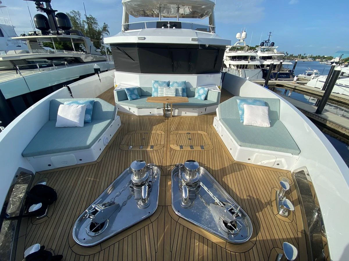 a deck with a boat and a couple of boats on it aboard PERSISTENCE Yacht for Sale