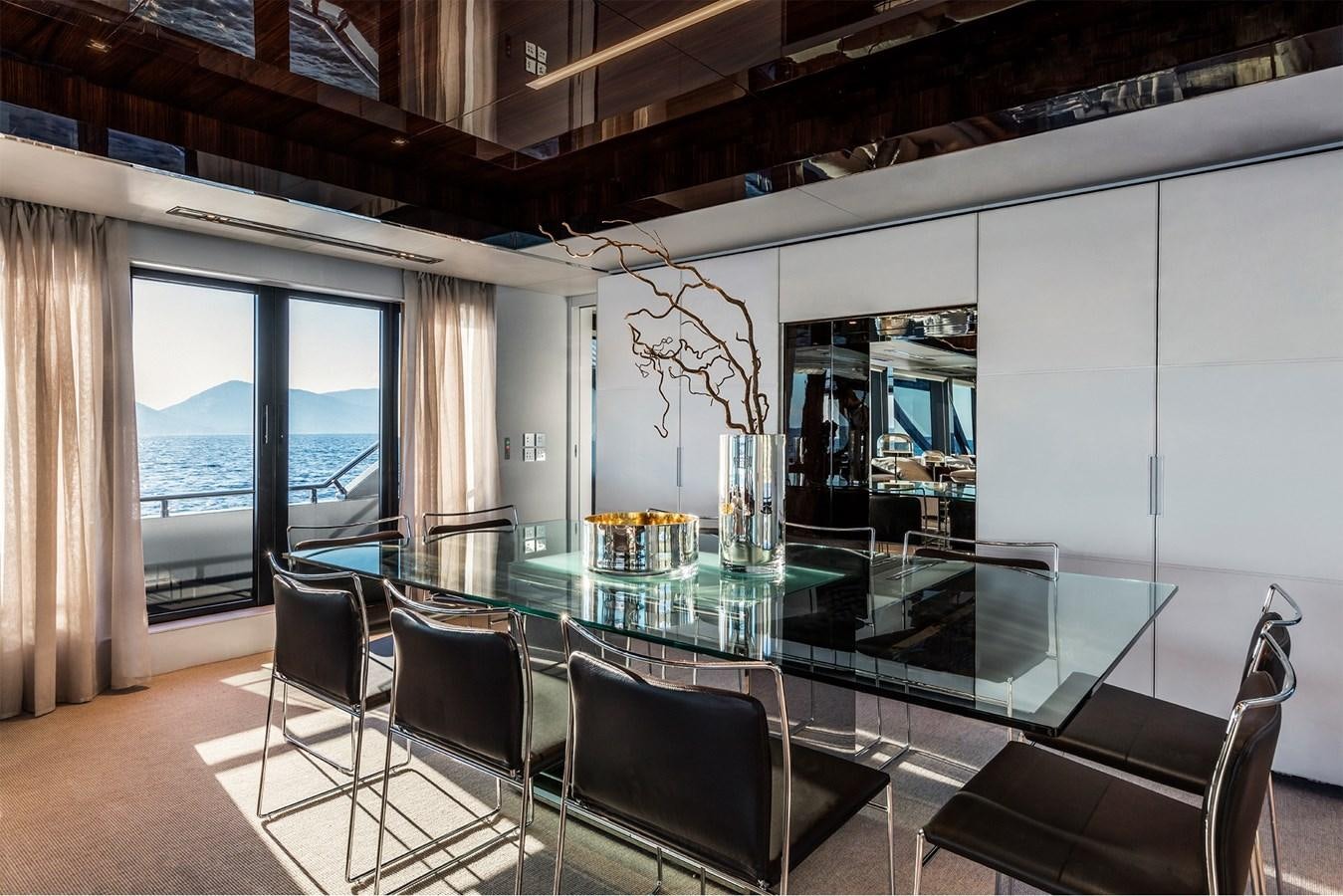 a large room with a table and chairs aboard TAKU Yacht for Sale