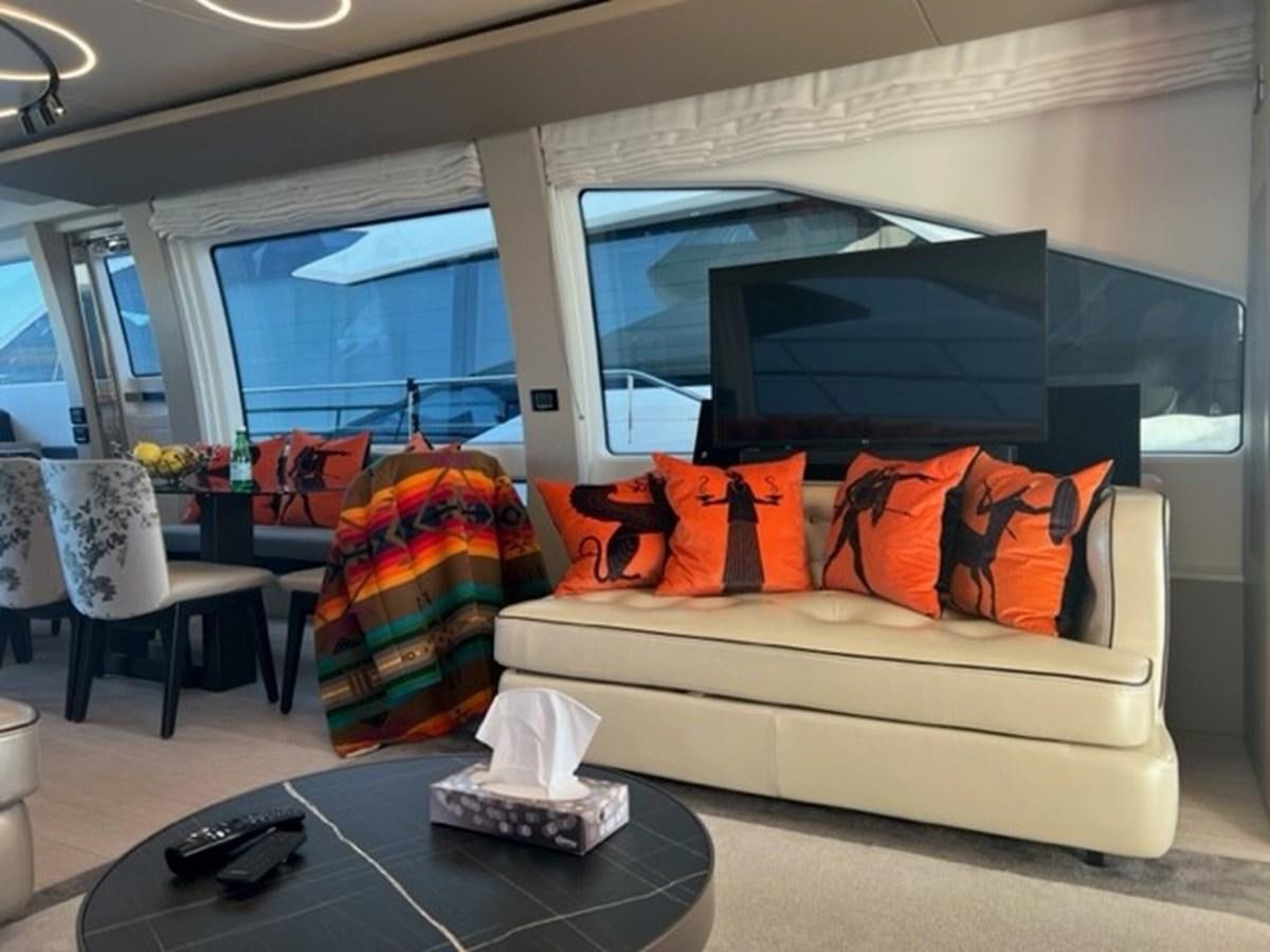 a living room with a couch and a tv aboard SOLSTICE Yacht for Sale