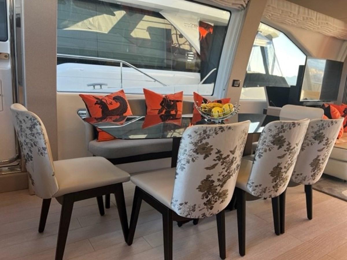 a table and chairs in a room aboard SOLSTICE Yacht for Sale
