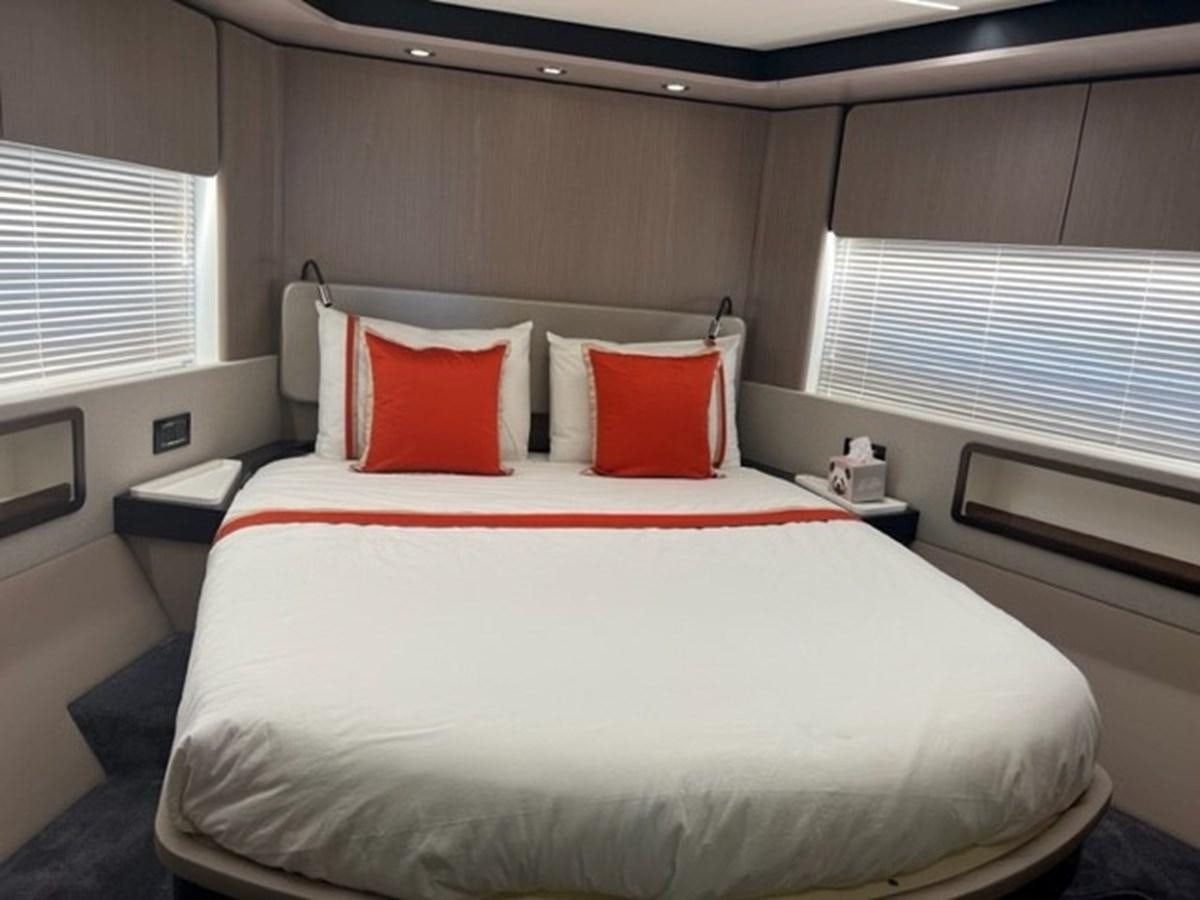 a bed with white sheets and pillows aboard SOLSTICE Yacht for Sale