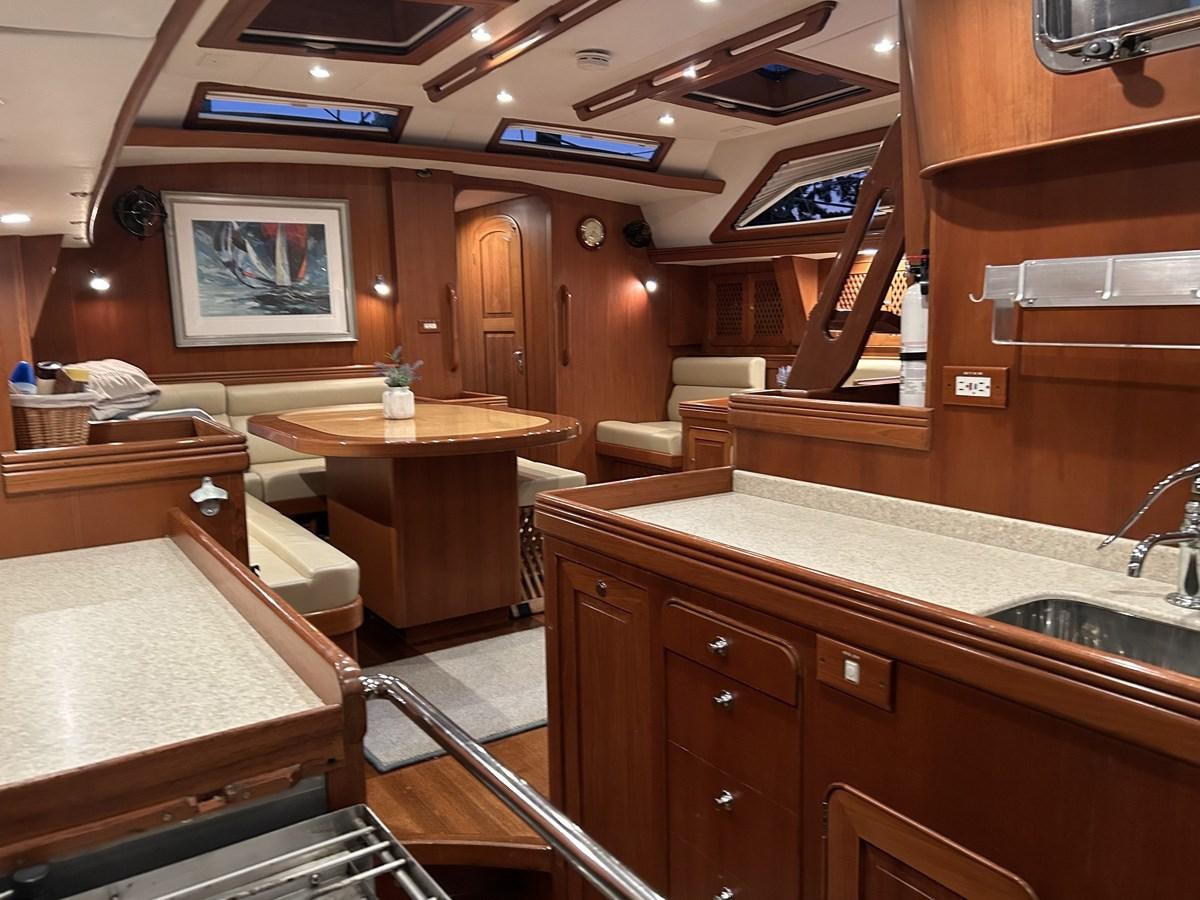 a kitchen with wooden cabinets aboard TRIUMPH Yacht for Sale