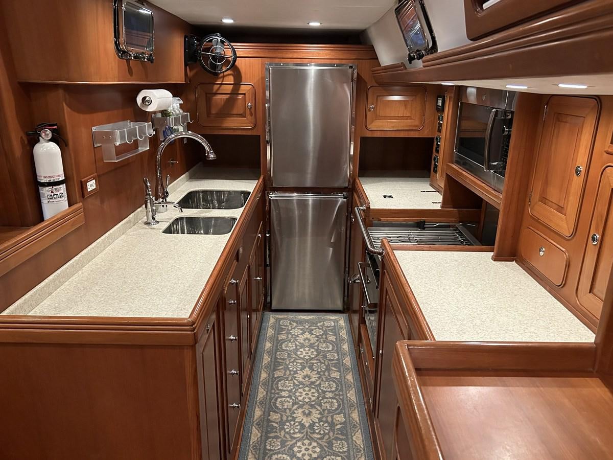 a kitchen with stainless steel appliances aboard TRIUMPH Yacht for Sale