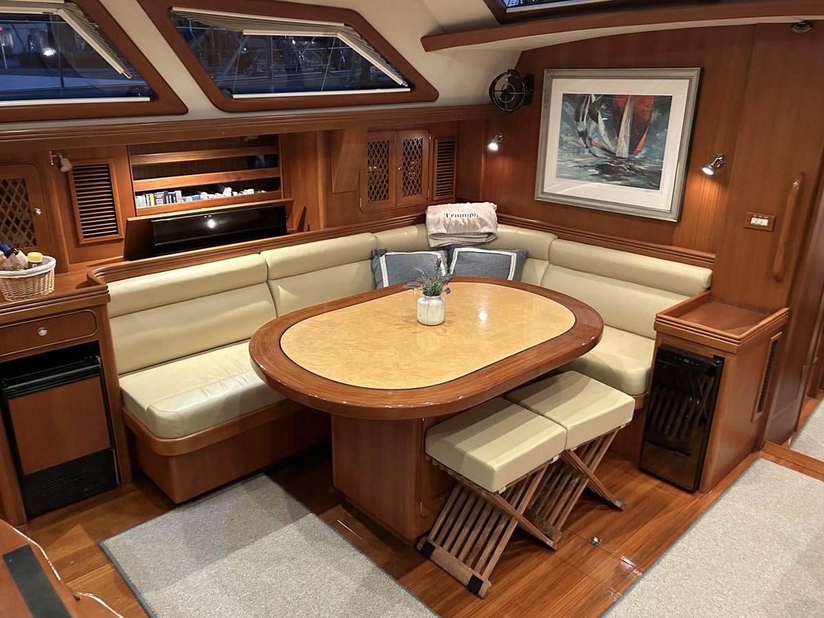 a room with a table and chairs aboard TRIUMPH Yacht for Sale