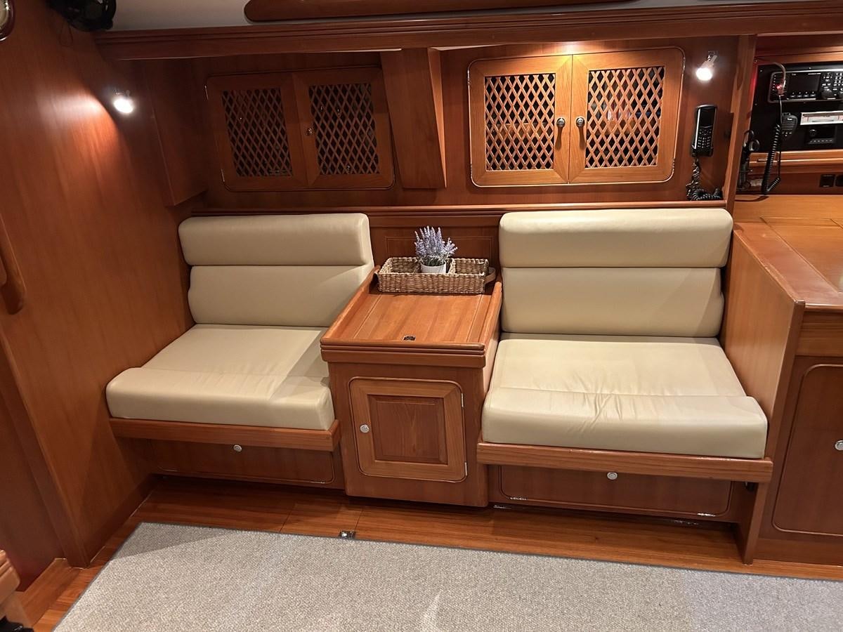 a room with a couch and a coffee table aboard TRIUMPH Yacht for Sale